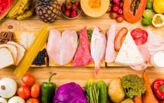 an assortment of healthy foods displayed on a wooden cutting board