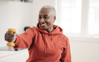 a woman holding out a hand weight and exercising